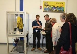 Engineering student demonstrates to club members.